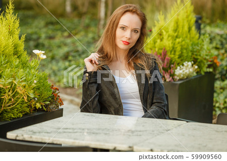 Fashion model in jeans jacket relaxing outdoor Fashion model in jeans jacket relaxing outdoor 59909560