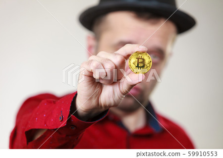 Man holding golden bitcoin 59910553