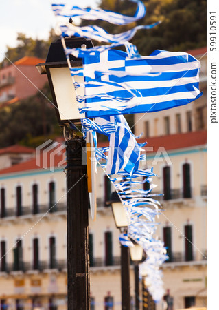 Greek flags waving against city buildings 59910591