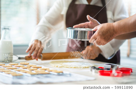 Happy Asian senior couple in brown aprons are 59911890