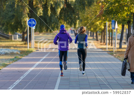 Young couple jogging in city in the morning 59912837