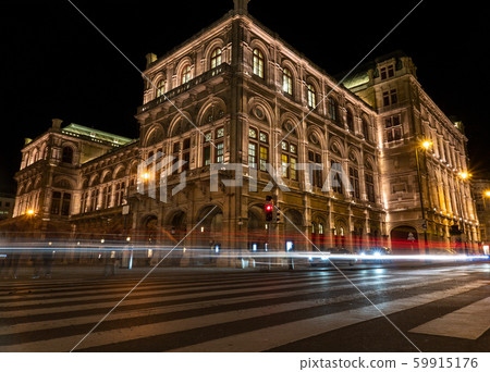 View of State Opera in Vienna, Austria during the night. Bright blue sky, car light trails 59915176