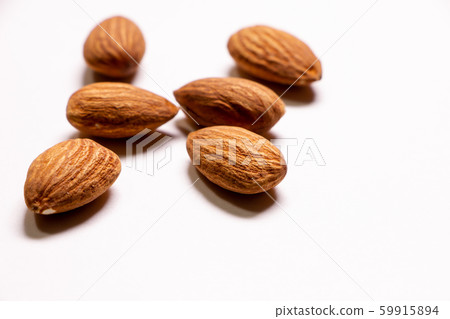almond. Nuts that are rich in vitamin E and dietary fiber and are said to be good for beauty and health. (White background) almond. Nuts that are rich in vitamin E and dietary fiber and are said to be good for beauty and health. (White background) 59915894