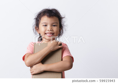 Asian little girl is hold a brown book and smiling 59915943