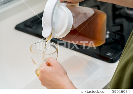 A woman poured tea A woman poured tea 59916084