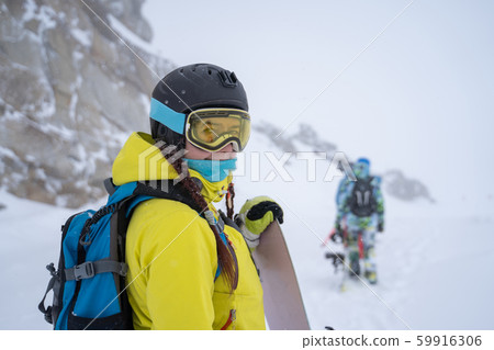 Photo of sports woman in helmet and glasses with snowboard at ski resort in afternoon Photo of sports woman in helmet and glasses with snowboard at ski resort in afternoon 59916306