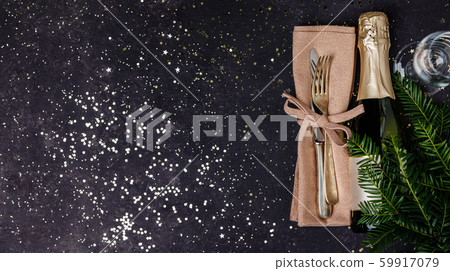 Champagne bottle with christmas decoration on dark background Champagne bottle with christmas decoration on dark background 59917079