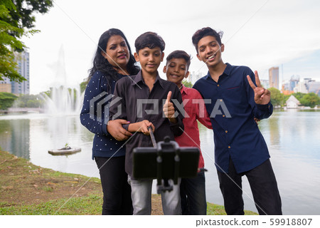 Portrait of Indian family relaxing together at the park Portrait of Indian family relaxing together at the park 59918807
