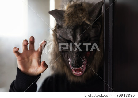 Model with scary wolf mask for Halloween party 59918889