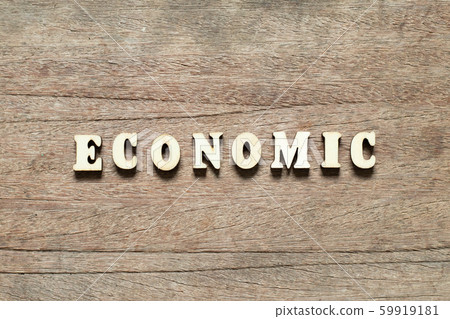 Letter block in word economic on wood background Letter block in word economic on wood background 59919181