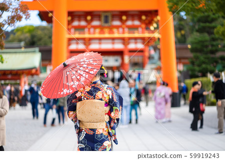 Geishas girl wearing Japanese kimono among red Geishas girl wearing Japanese kimono among red 59919243