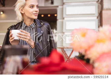Pretty lady enjoying her morning coffee outdoors Pretty lady enjoying her morning coffee outdoors 59920114