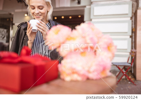 Cheerful girl waiting for her friend on her birthday Cheerful girl waiting for her friend on her birthday 59920124