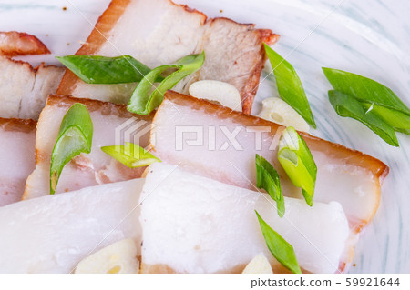 Pieces of layered lard with cut green onions and garlic 59921644