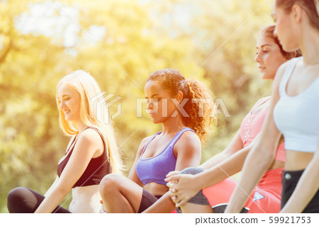group of teen woman mix race doing workout sport exercise warm up at outdoor park 59921753