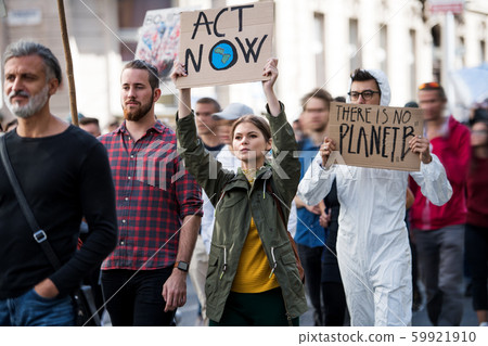 People with placards and protective suit on global strike for climate change. People with placards and protective suit on global strike for climate change. 59921910