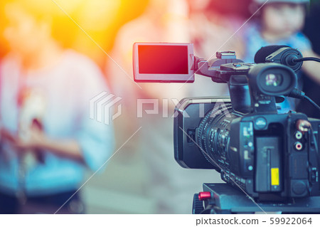 Video camera camcorder operator working at live event broadcasting 59922064
