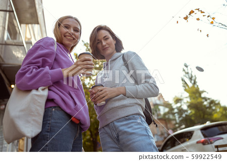 Low angle picture of stylish females that posing on camera Low angle picture of stylish females that posing on camera 59922549