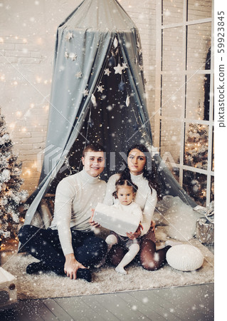 Beautiful young family under baldachin. Christmas Beautiful young family under baldachin. Christmas 59923845