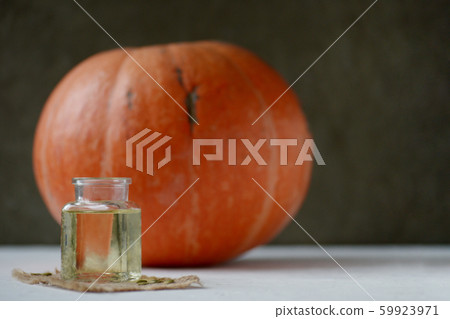 orange pumpkin and bottle with pumpkin oil on orange pumpkin and bottle with pumpkin oil on 59923971