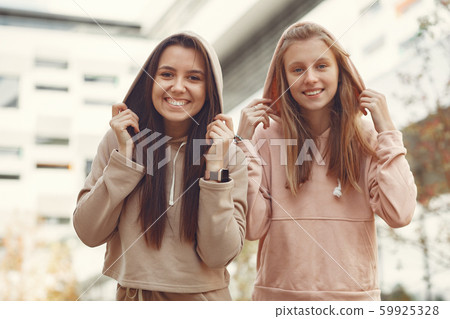Elegant and stylish girls in a autumn park Elegant and stylish girls in a autumn park 59925328