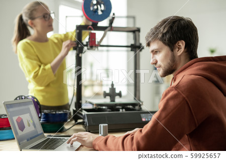 Serious man concentrating on work over new objects on background of colleague 59925657
