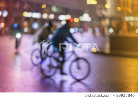 Abstract unrecognizable people, riding bikes, night city, illumination bokeh, motion blur. Healthy 59925846