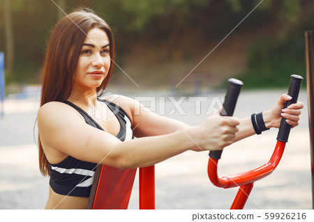 Sports girl in a black top training in a summer park Sports girl in a black top training in a summer park 59926216