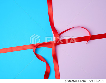 red satin ribbon on a colored background red satin ribbon on a colored background 59926218