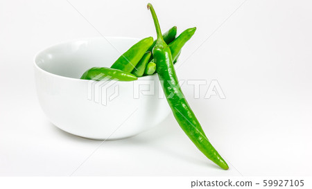 Green chili pepper in the bowl, isolated Green chili pepper in the bowl, isolated 59927105
