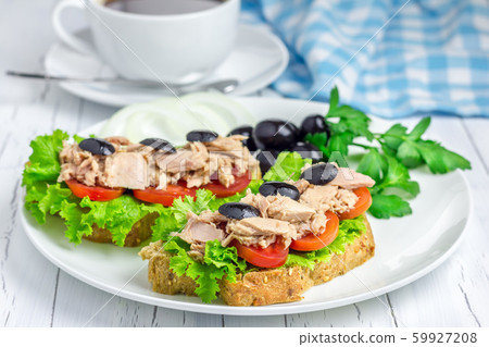 Tuna fish sandwiches on the white plate and coffee Tuna fish sandwiches on the white plate and coffee 59927208