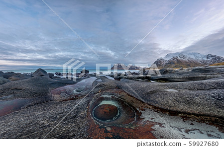 The Dragons Eye is a unique natural rock formation at Uttakleiv Beach, Lofoten Islands, Norway 59927680