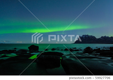 Northern lights, Aurora Borealis, with nice reflection at the Uttakleiv Beach, Lofoten, Norway 59927706