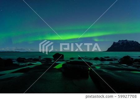Northern lights, Aurora Borealis, with nice reflection at the Uttakleiv Beach, Lofoten, Norway 59927708