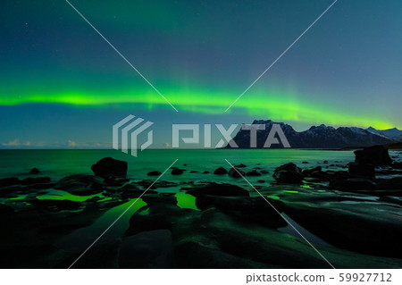 Northern lights, Aurora Borealis, with nice reflection at the Uttakleiv Beach, Lofoten, Norway Northern lights, Aurora Borealis, with nice reflection at the Uttakleiv Beach, Lofoten, Norway 59927712