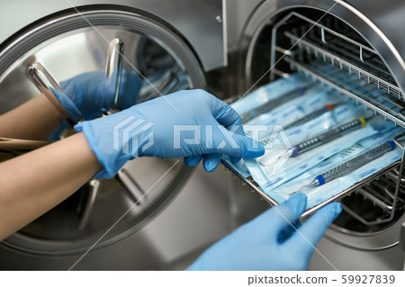 Doctor is taking dental probe from sterilize machine 59927839