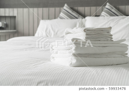 White towel on bed decoration in bedroom interior White towel on bed decoration in bedroom interior 59933476