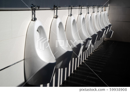 Art light and shadow of men's restroom with white porcelain urinals in line. Modern clean public toilets with tiles.  59938908