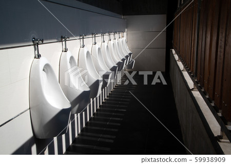 Art light and shadow of men's restroom with white porcelain urinals in line. Modern clean public toilets with tiles.  59938909