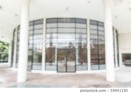 Blur school or office building background exterior view to lobby entrance glass window wall with blurry light bokeh 59941195