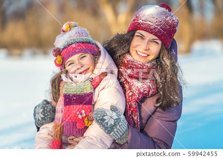 Mother and daughter playing in winter park Mother and daughter playing in winter park 59942455