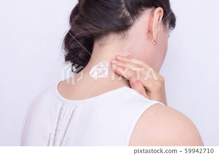 A girl smears a neck with a healing and anti-inflammatory ointment to relieve muscle stiffness and pain, close-up, neuralgia A girl smears a neck with a healing and anti-inflammatory ointment to relieve muscle stiffness and pain, close-up, neuralgia 59942710
