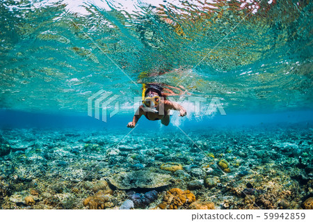 Young woman swimming underwater. Snorkeling in the tropical ocean 59942859