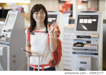 Airport check-in female 59943177