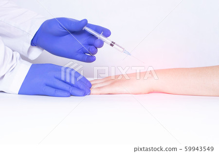 Doctor injects blockade into wrist joint with chondroprotector and analgesic drug, close-up, medical, ozone therapy, polyarthritis 59943549