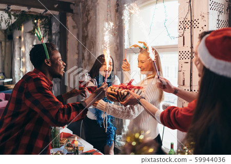 Group of friends standing together and toasting drinks Group of friends standing together and toasting drinks 59944036