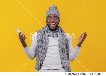 Black man screaming and raising hands in the air 59945078