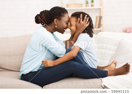 Happy black mom hugging her little girl Happy black mom hugging her little girl 59945153