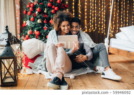 Couple in love making video call on a tablet Couple in love making video call on a tablet 59946092