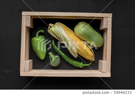 Picture of fresh vegetables inside wooden frame on black Picture of fresh vegetables inside wooden frame on black 59946233
